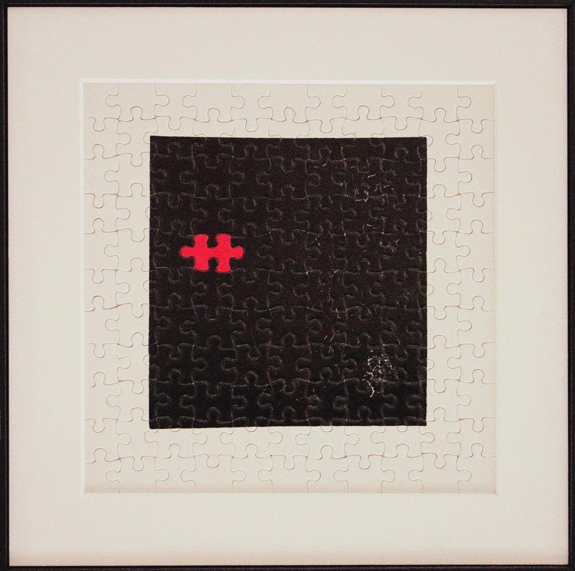 Suprematic Dilemma, 2024 - a completed jigsaw puzzle, its centre a solid black square on white, with one red piece set slightly off-centre.